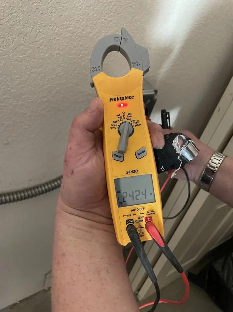 Voltage testing with clamp meter during Ceiling Fan Installation in Pelican Marsh